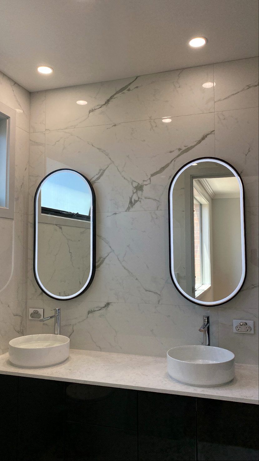 Bathroom with two LED-backlit mirrors, downlights and powerpoints above a double vanity